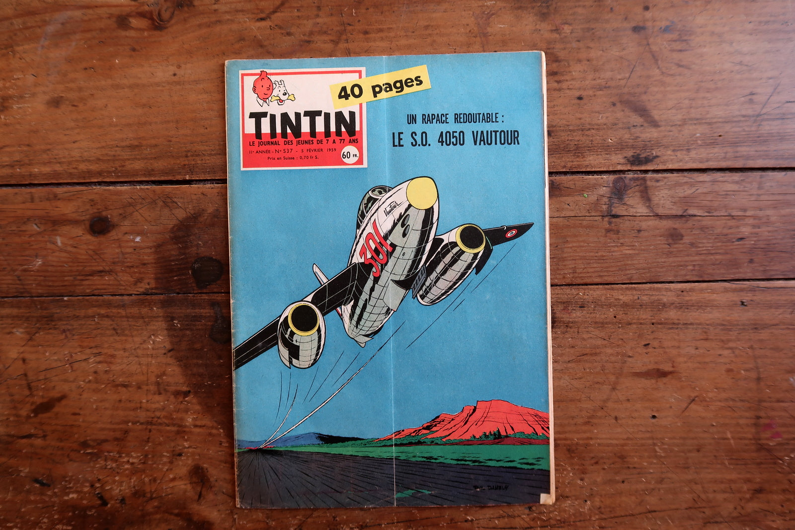 Close-up of the cover art on a 1959 French Tintin comic book magazine showing a dynamic S.O. 4050 Vautour jet in flight, with the iconic Tintin header and issue details.

