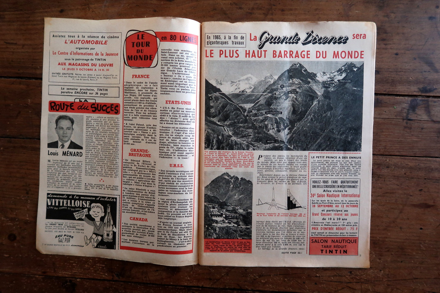 Open view of original Tintin magazine N°519 showing interior pages including La Cavale d'Or by Willy Vandersteen, Sciences et Actualités feature on the Vespa 400 microcar, and a world news spread on La Grande Dixence dam construction.

