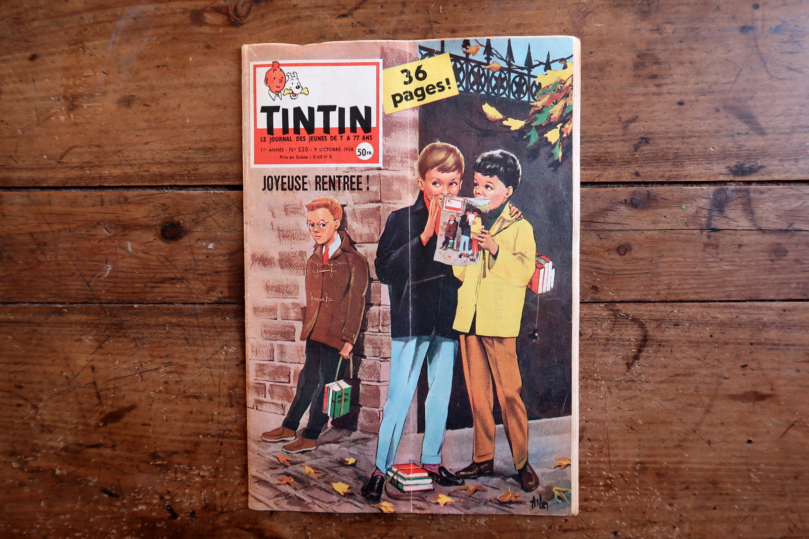 Close-up of the cover art on a 1958 French-Belgian Tintin comic magazine showing three schoolboys in a cheerful back-to-school scene on an autumn street, with the iconic Tintin header and "Joyeuse Rentrée!" greeting.

