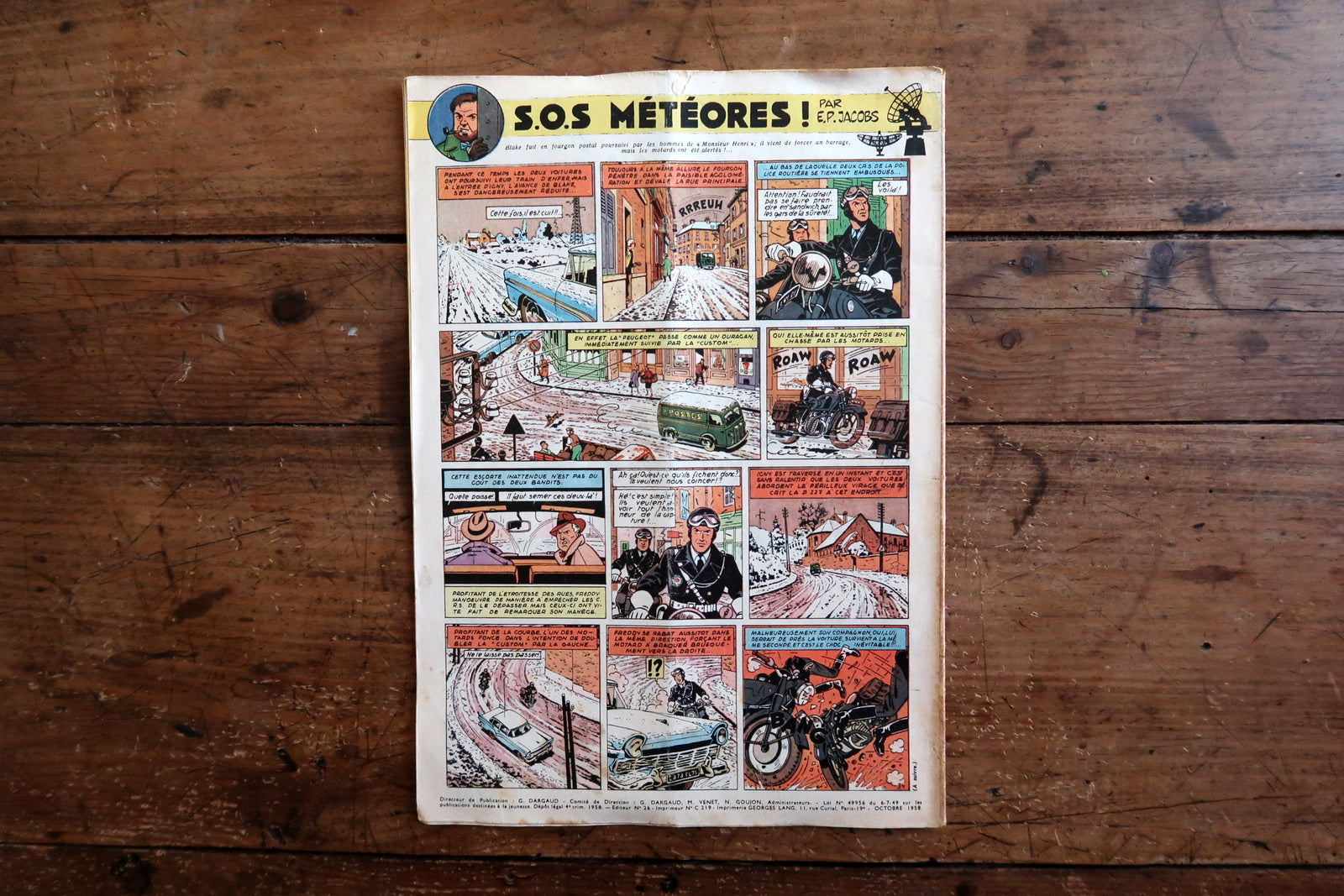 Vintage October 9, 1958 Tintin magazine issue N°520 displayed flat, measuring approximately 8.3 x 11.8 inches, with French language text and bande dessinée artwork, showing a visible vertical cover fold.

