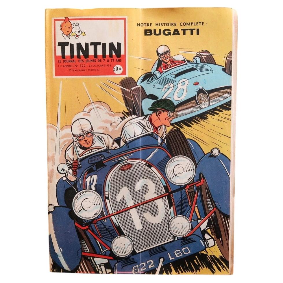 Front cover of Journal Tintin N°522 from October 23, 1958, featuring a masterpiece of mid-century graphic illustration: a vintage Bugatti racing car, number 13, plate 622 L60, thundering toward the viewer with two goggled drivers hunched against the slipstream and a blue competitor bearing down from behind, on a yellow background that makes the deep cobalt blue of the Bugatti sing.


