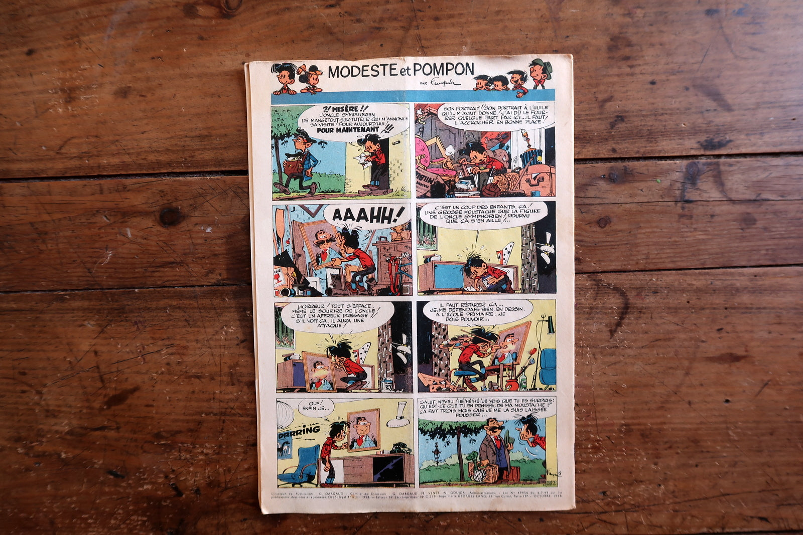 Collectible 1958 Journal de Tintin featuring a complete Bugatti racing story on the cover, interior content including a full-page color Modeste et Pompon by Franquin on the back cover, and Le Grand Défi (Michel Vaillant) by Jean Graton.


