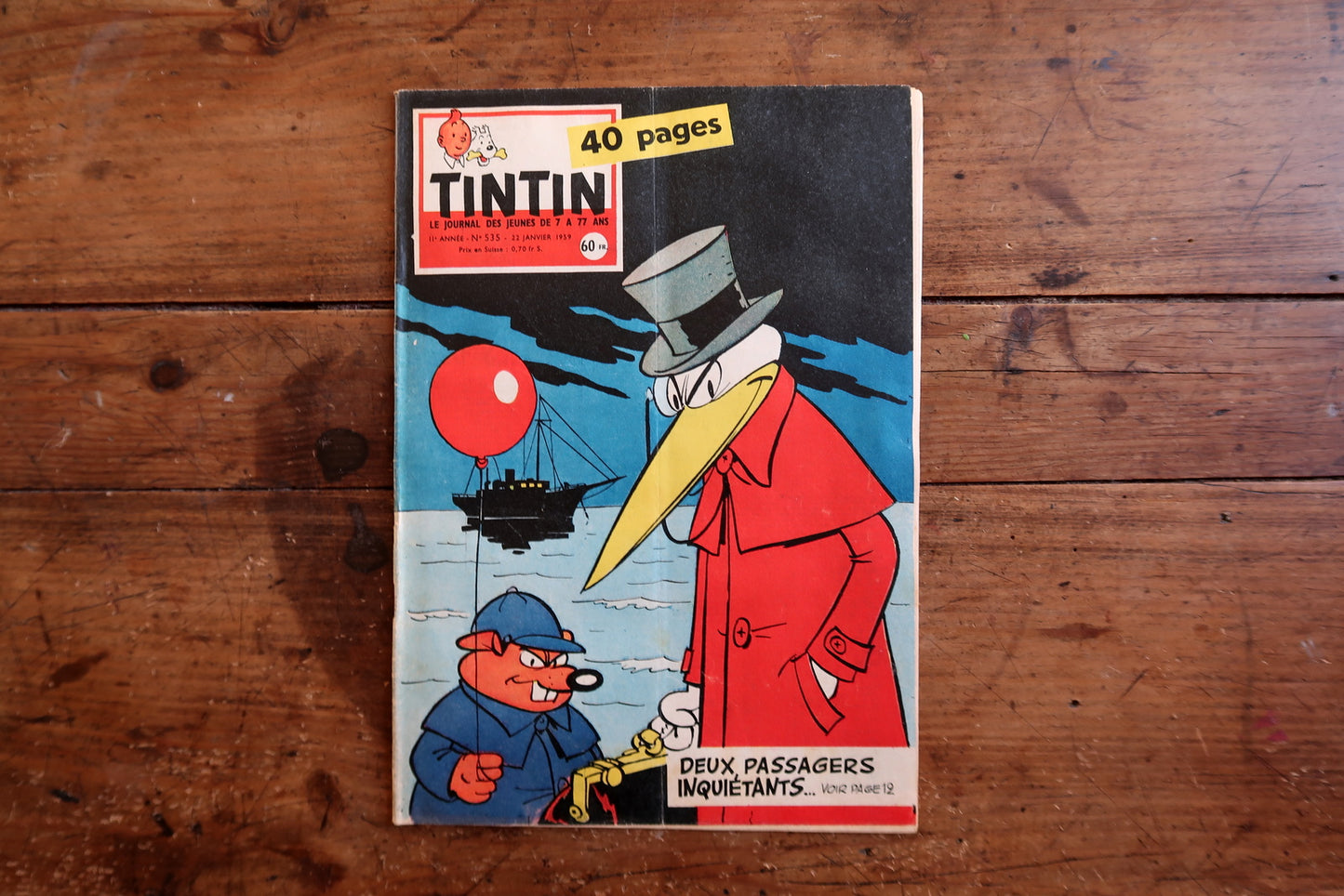 Vintage February 5, 1959 Tintin magazine issue N°535 displayed flat, measuring approximately 8.3 × 11.8 inches, with French language text and bande dessinée artwork, in good condition with only light edge wear.

