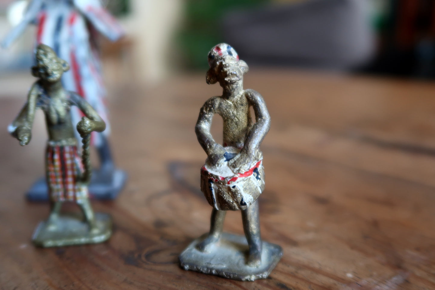Full group shot of a complete mid-century French colonial-era ceremonial scene figurine set, comprising four objects with original hand-painted surfaces and honest age-related chipping consistent with 65–75 years of age.

