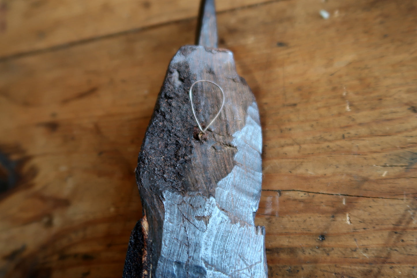 Vintage African export art mask from the mid-20th century, carved in ebonized hardwood with a tall pointed horn, lightly closed lips, and a well-developed patina with warm undertones visible in raking light.

