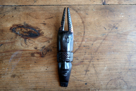 Vintage West African tribal mask featuring tall double‑horn headdress


