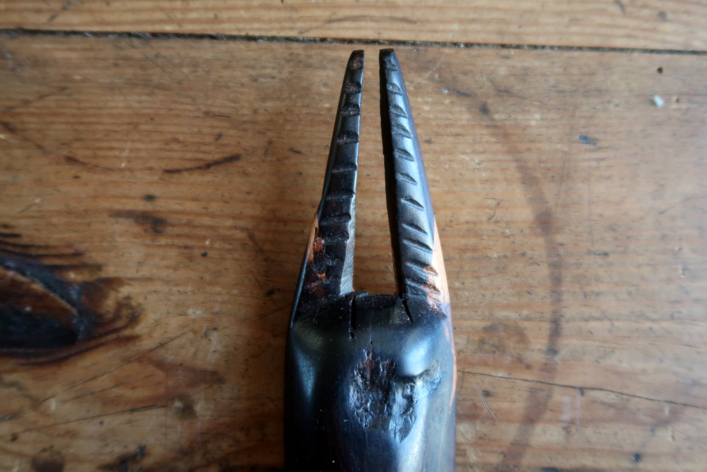 Traditional African ceremonial mask with stylized features and double horns

