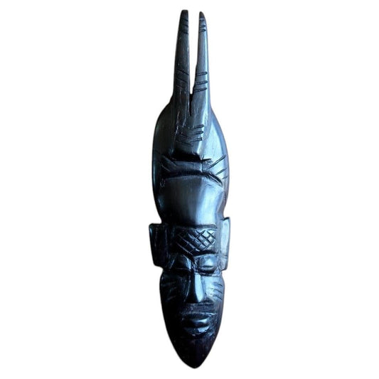African ebonized wood mask — carved West African mask with tall twin‑prong crest

