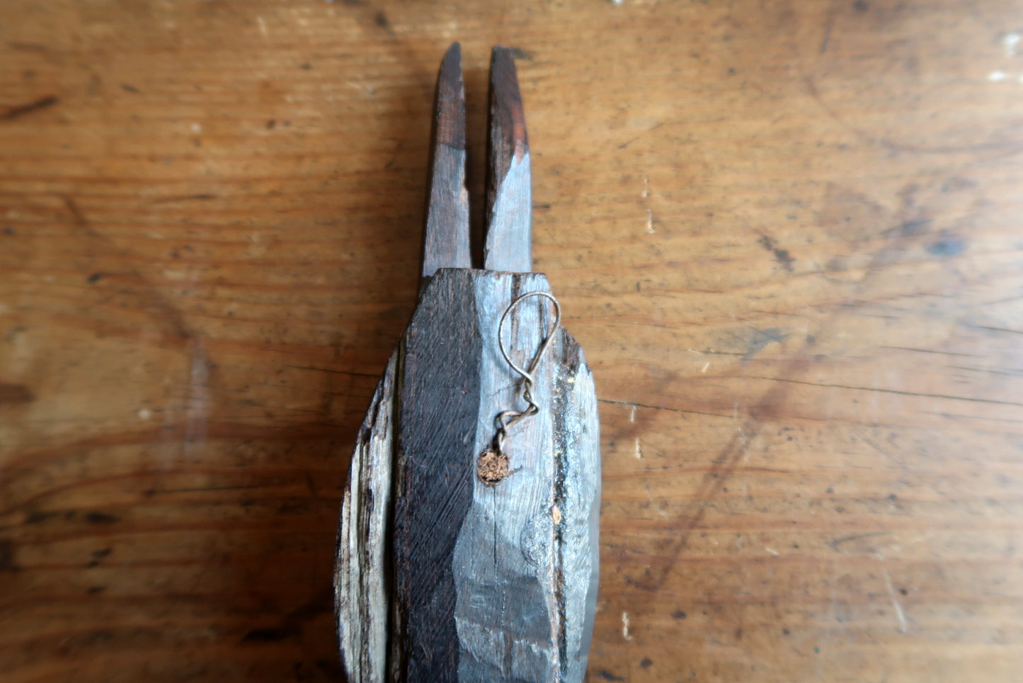 African ceremonial mask — expressive carved face and tall split‑prong crown

