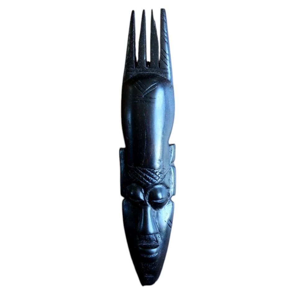 African ebonized wood mask — carved mask with elegant four‑prong crest

