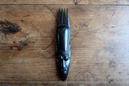 African ebonized wood mask — carved mask with elegant four‑prong crest


