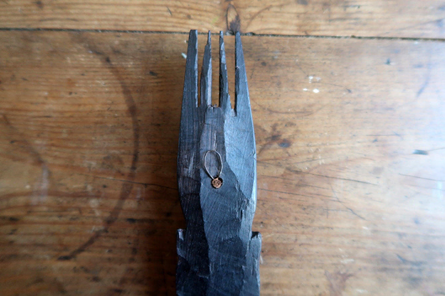 Carved African mask — dark ebonized wood with elongated features and crest

