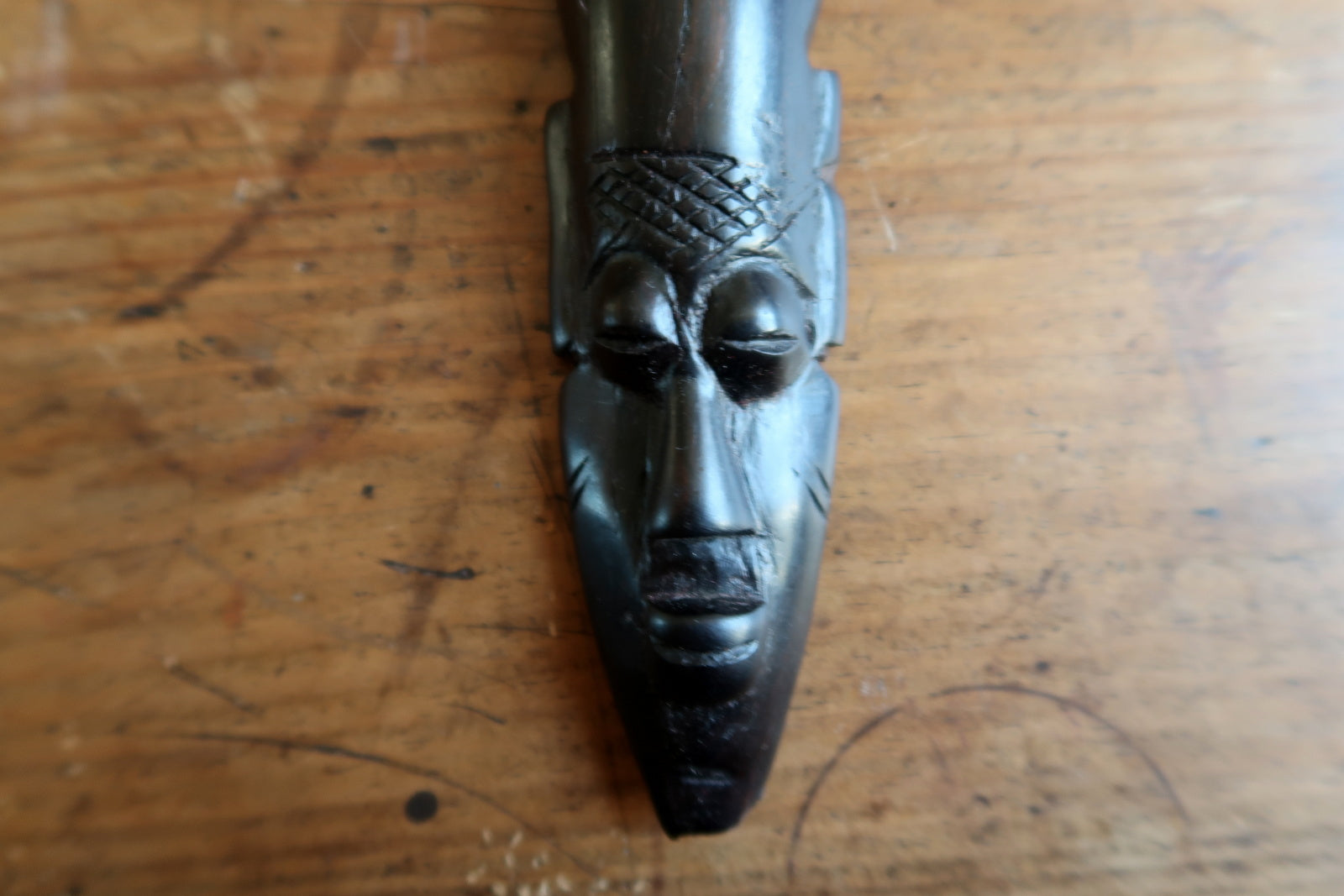 West African wood mask — hand‑carved mask with tall split‑prong headdress

