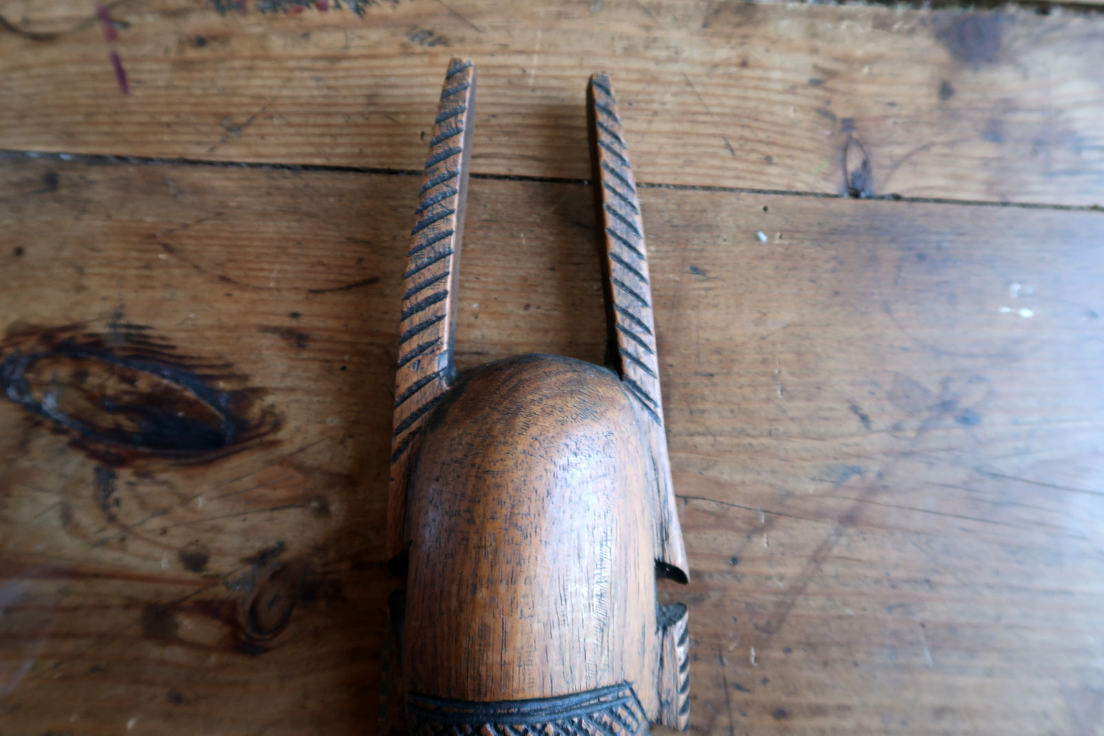 Traditional African mask — carved crest and symbolic facial patterns


