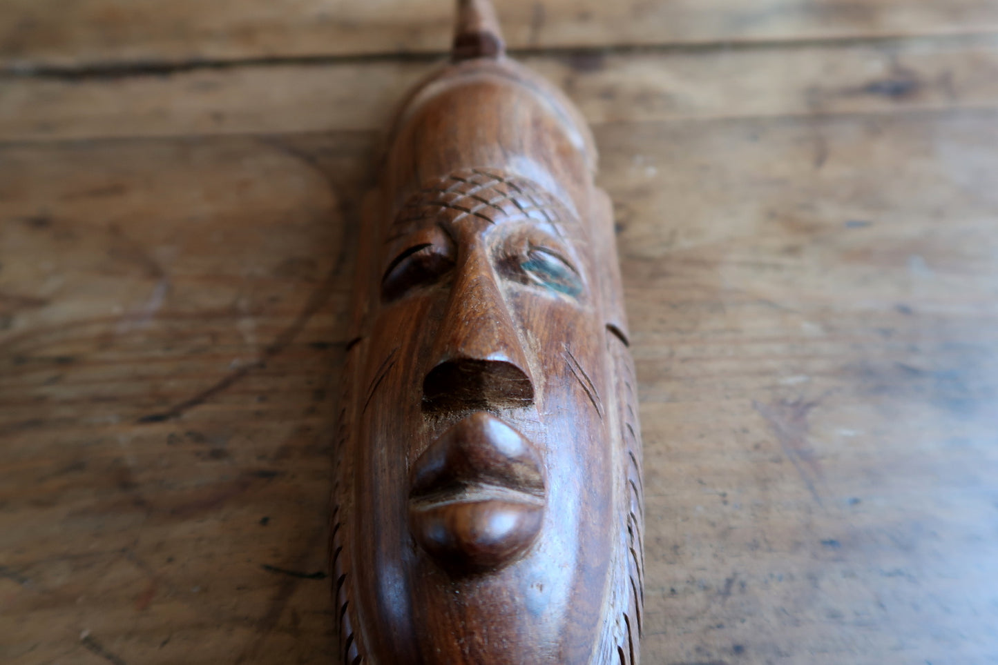 Traditional Baoule mask — symbolic horn motif and serene expression

