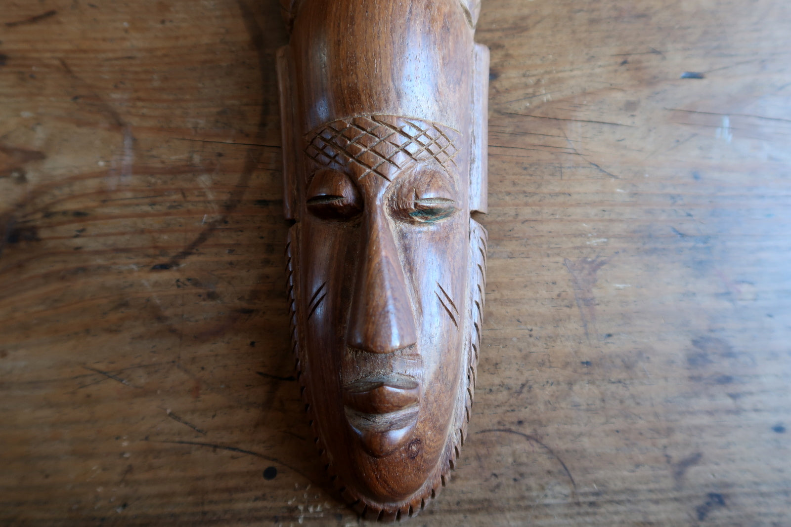 African wall mask — decorative hardwood mask with vertical horn

