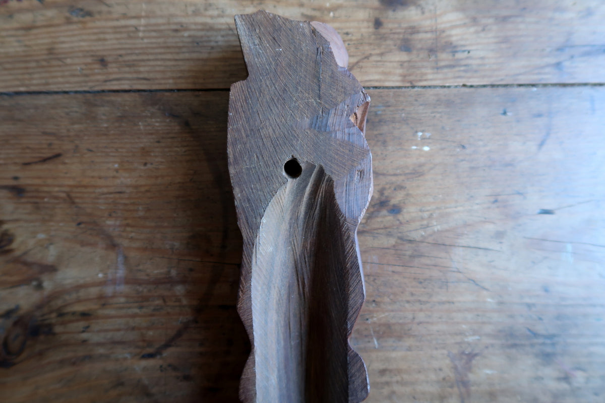 Left side profile shot illustrating the slim 4 cm depth and narrow architectural silhouette of the carved West African mask.

