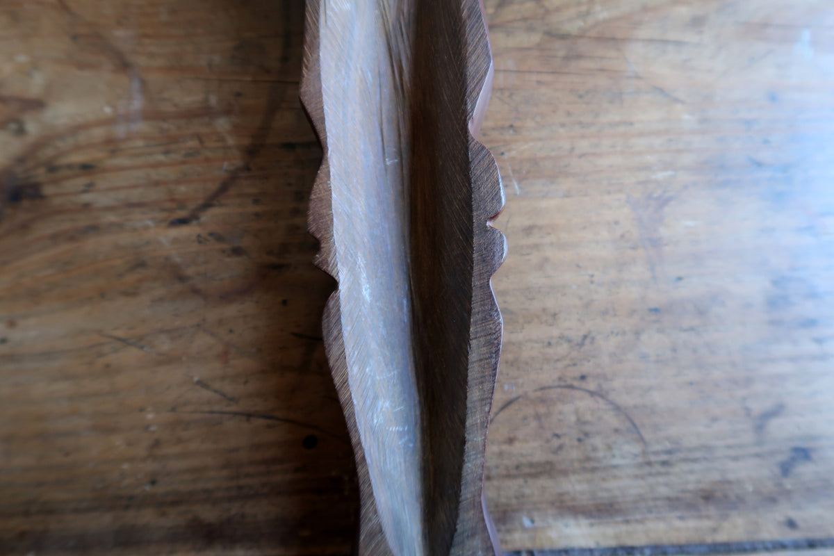 Right side profile view demonstrating the contrast between the polished front face and the raw natural wood on the back.