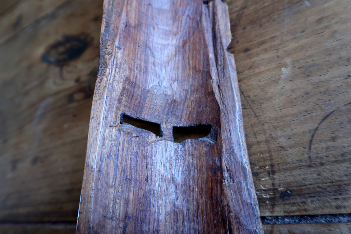 Full view of the raw, unpolished reverse side displaying the hollowed interior and natural carved wood texture.