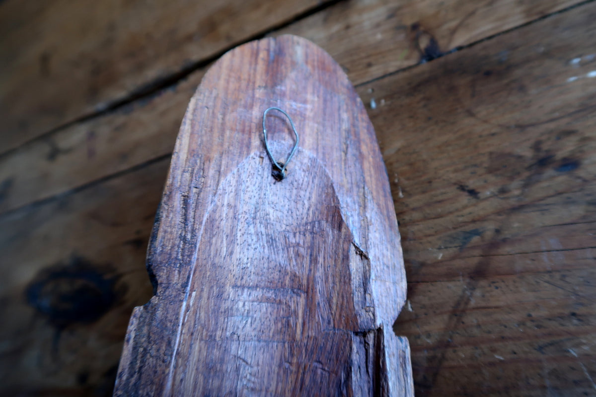Extreme close-up showing the rich warm brown polish and undulating natural hardwood grain across the smooth front face.