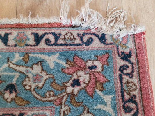 Handmade Persian Tabriz rug featuring deep red and beige hues

