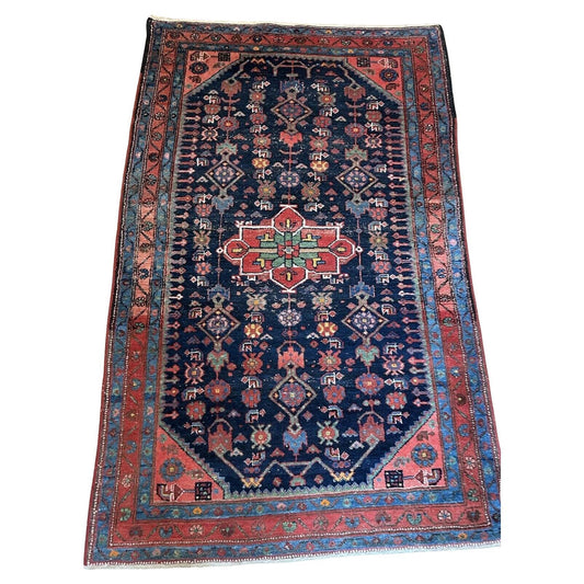 Close-up of intricate geometric motifs on a Persian Hamadan rug

