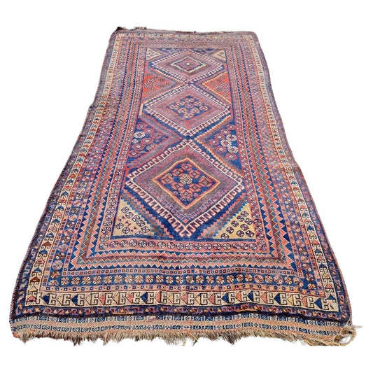 Antique Persian Gashkai rug with red and navy geometric patterns

