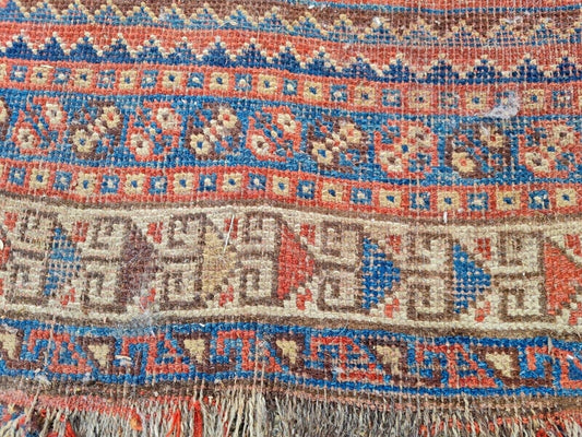 Close-up of hand-knotted wool texture on Persian tribal rug

