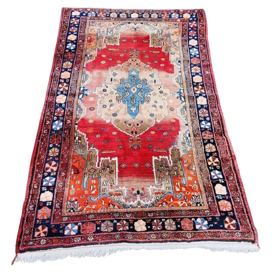 Antique Persian Malayer rug with red field and geometric motifs

