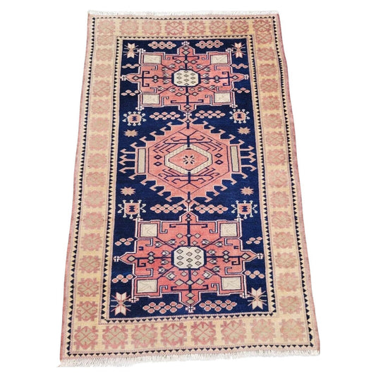 Handmade vintage Turkish Kars rug in muted pink and blue

