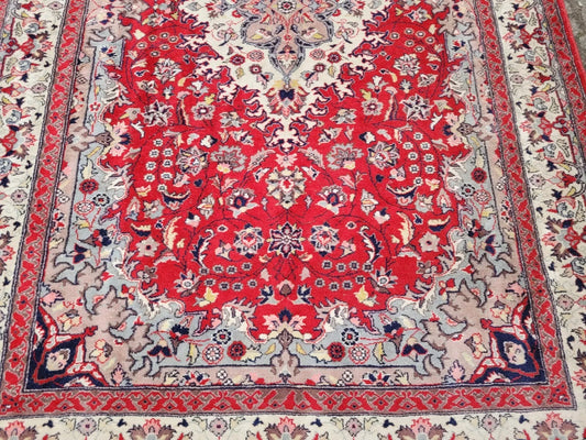 Decorative red and patterned rug with intricate designs