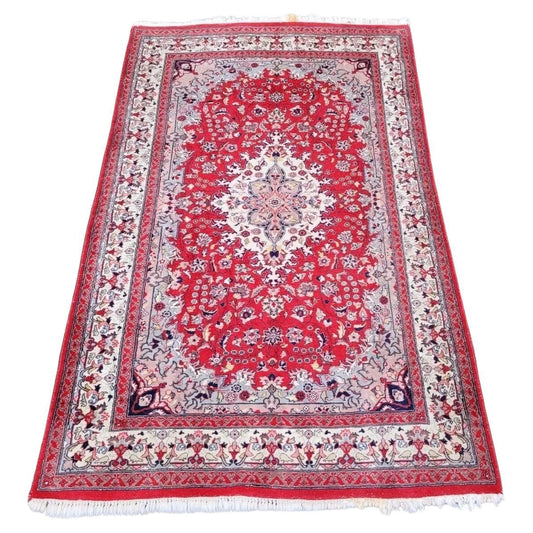 Hand-knotted Persian Sarouk rug with a central medallion.
