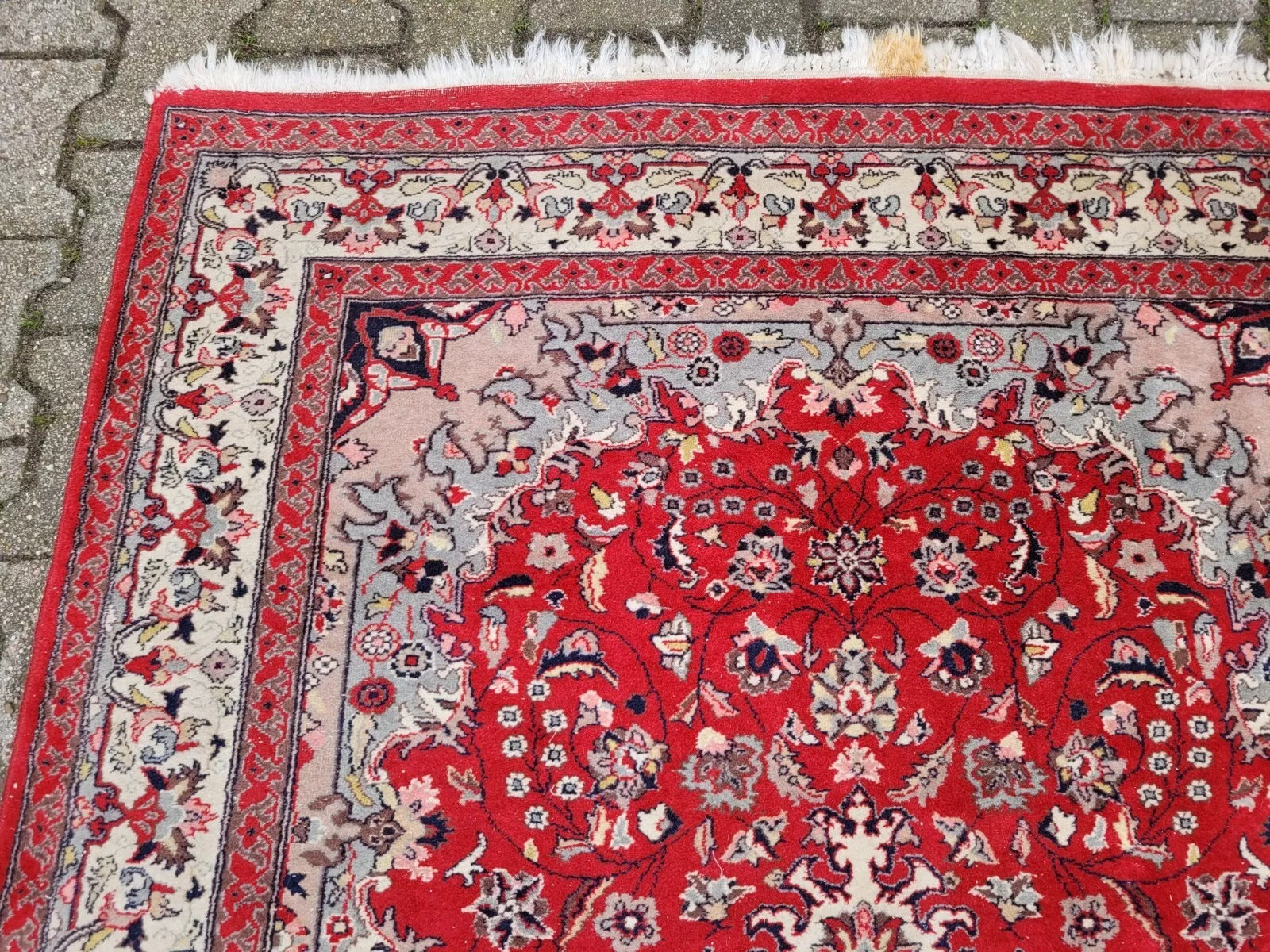 Wool rug showing a classic central medallion motif.
