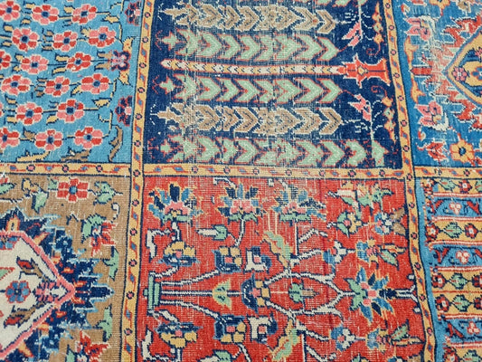 Wool rug featuring a grid of floral motifs and boteh patterns.
