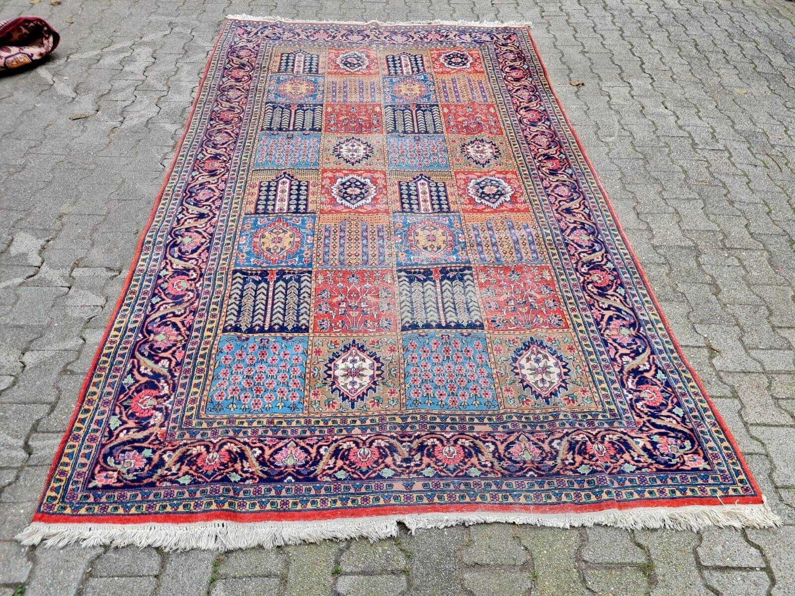 Colorful patterned rug on a stone pavement