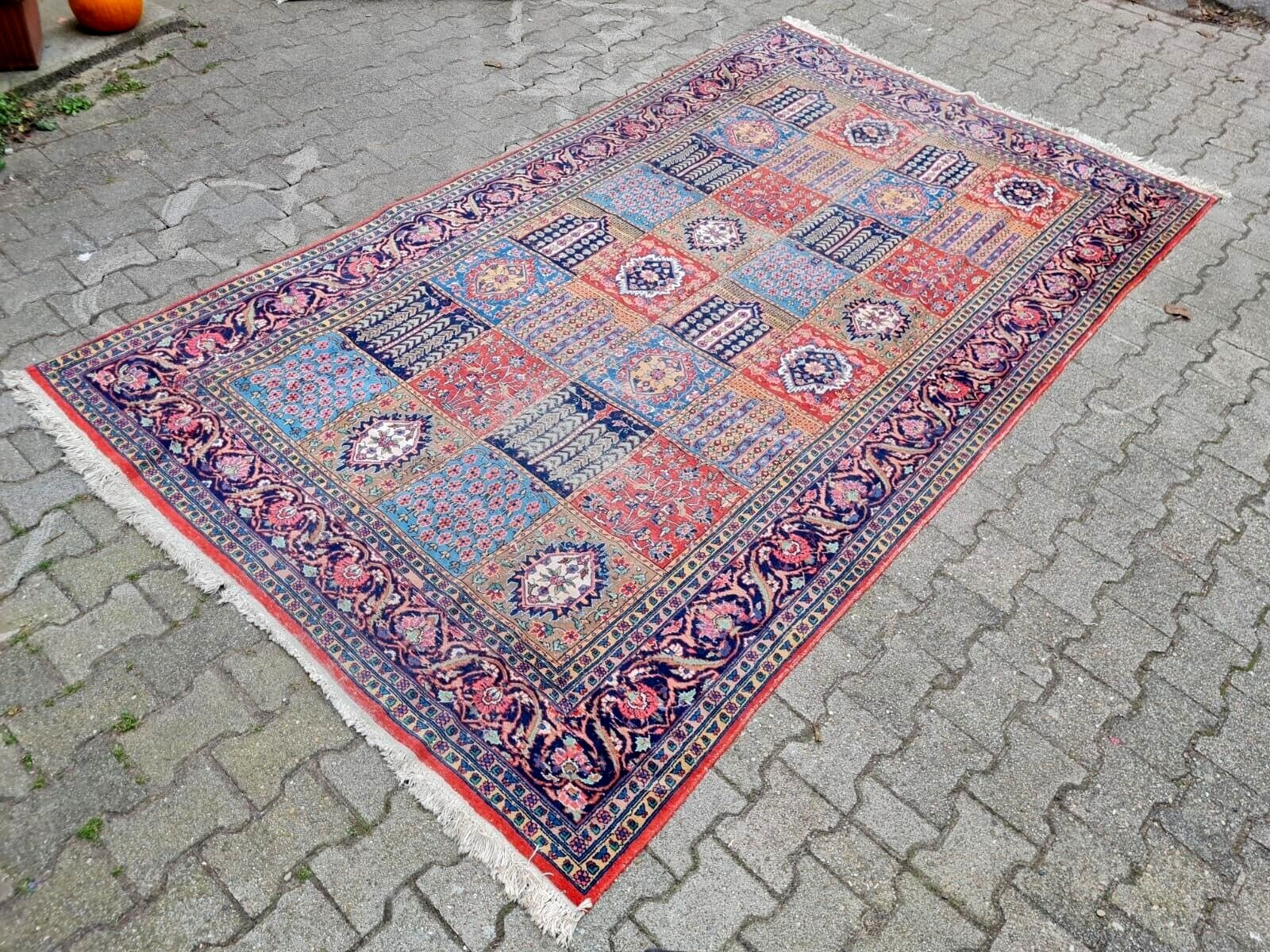 Hand-knotted tribal rug with an intricate panel layout.
