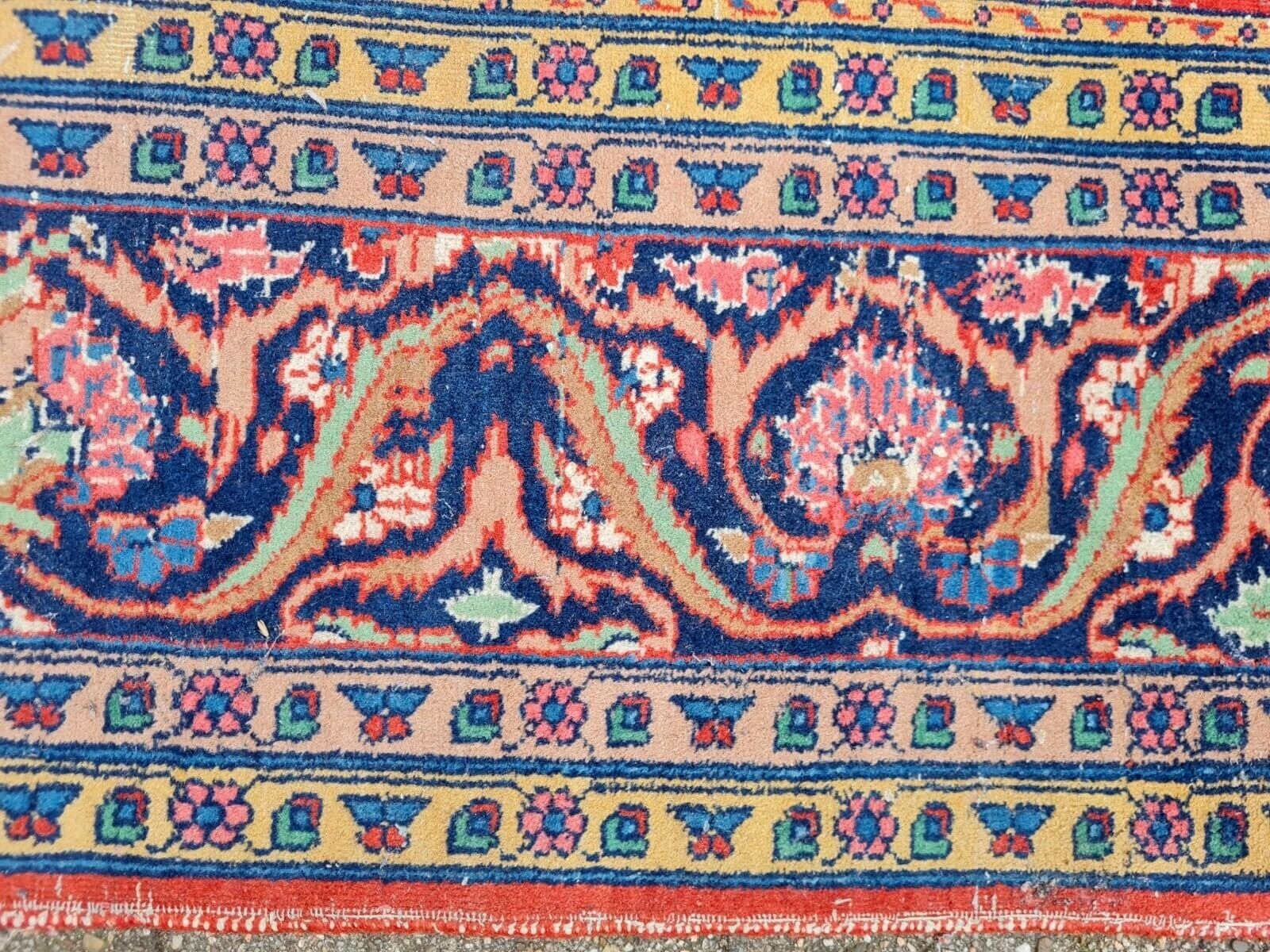 Antique rug with vibrant hues in each rectangular panel.
