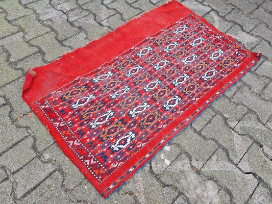 Wool flat-weave rug featuring traditional Turkmen "gul" motifs.
