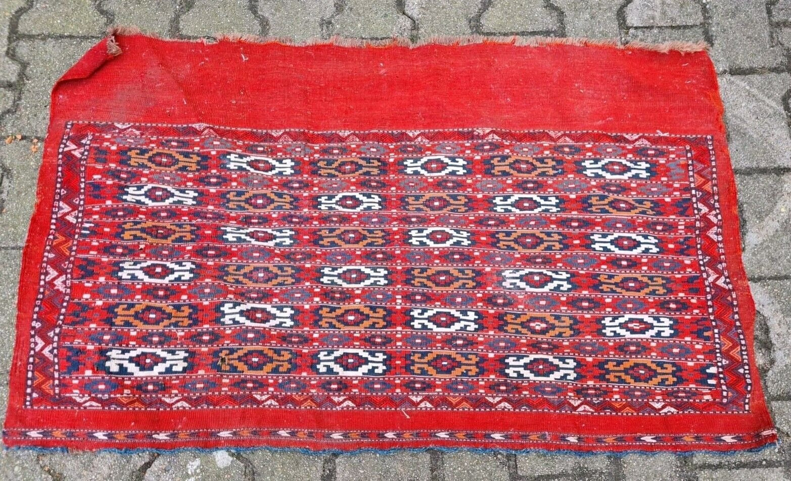 Overhead view of a collectible Central Asian tribal rug.
