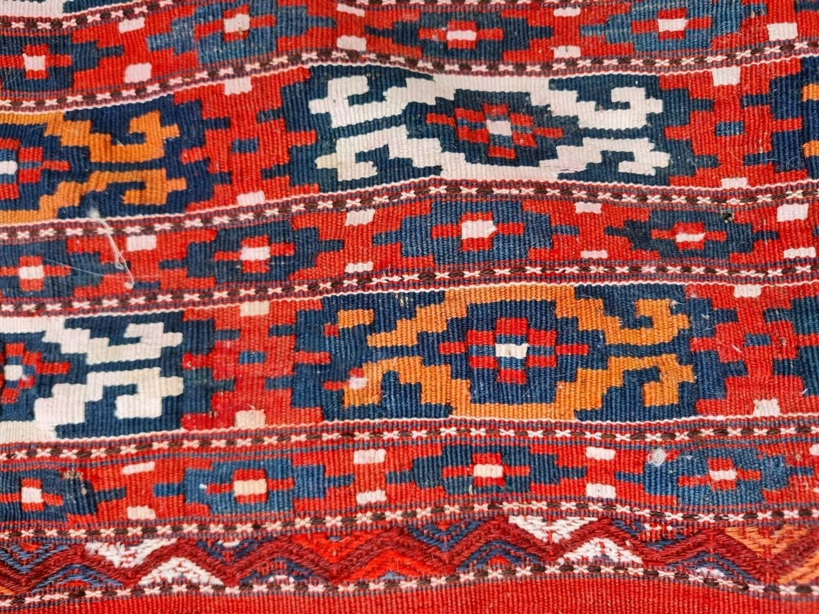 Handwoven wool rug with minor wear and charming patina.
