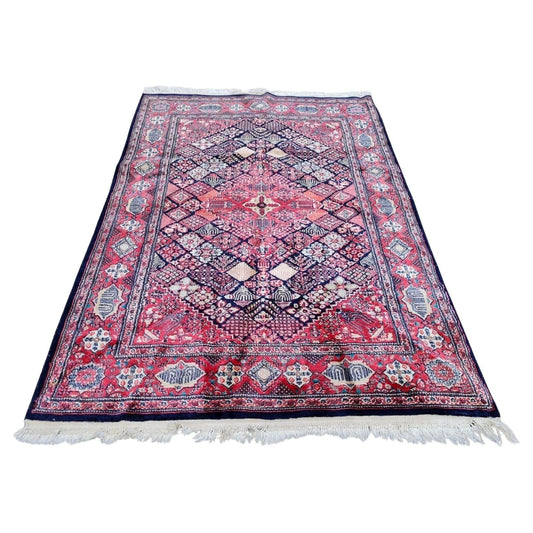 Handmade antique Persian Kashan rug with central medallion.
