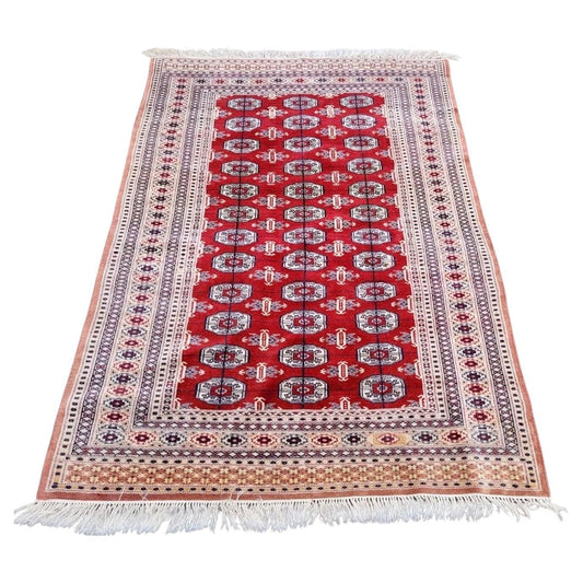Handmade vintage Bukhara rug with classic gul motifs

