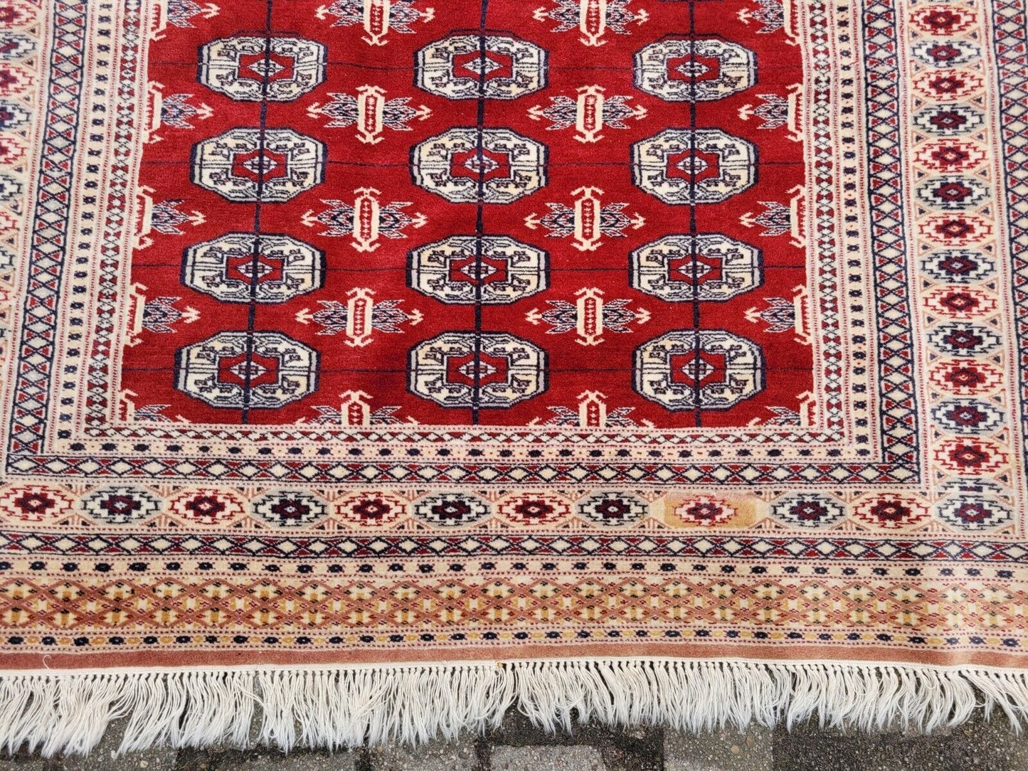 Red and brown motif on cream wool background

