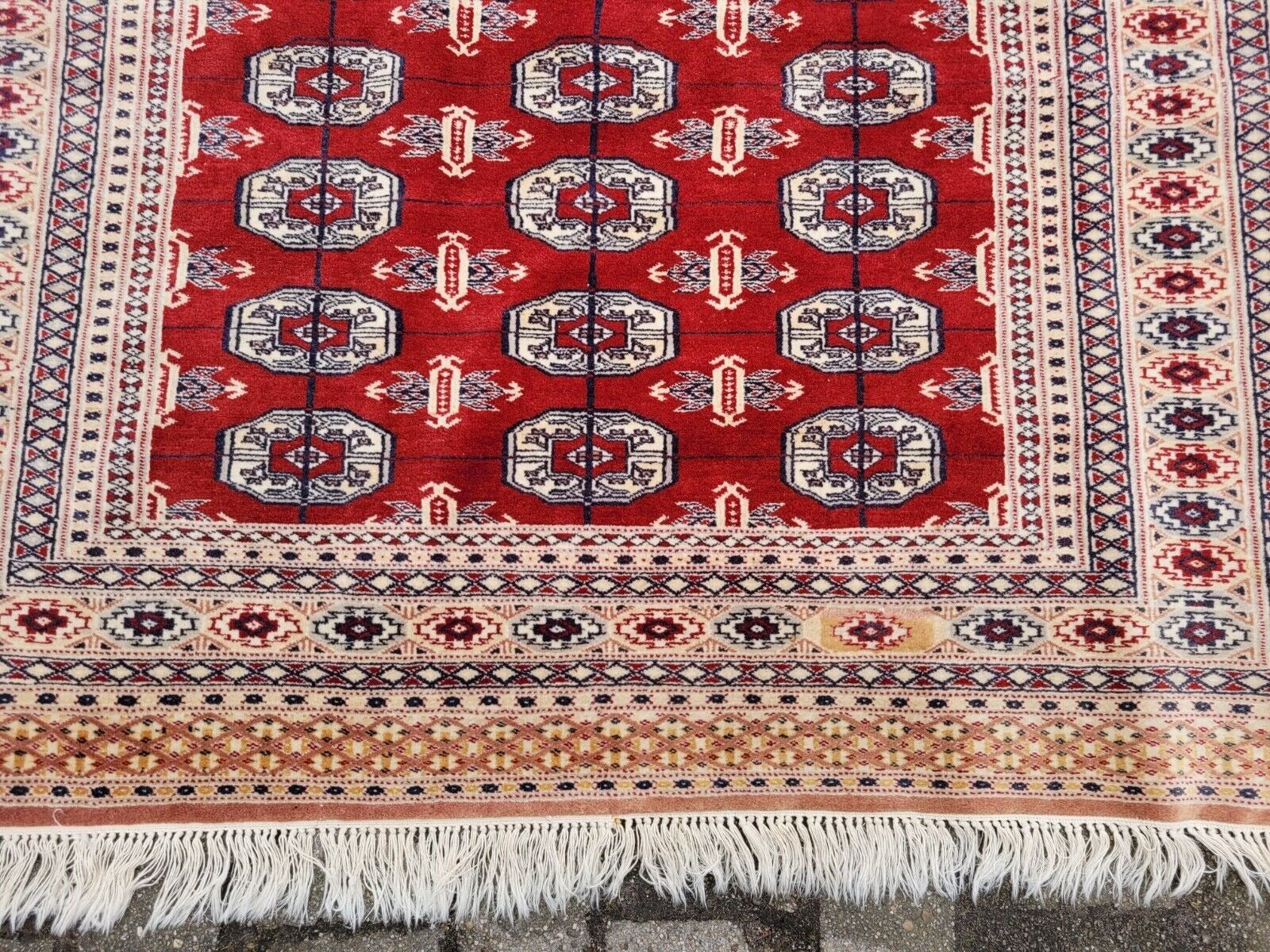 Red and brown motif on cream wool background

