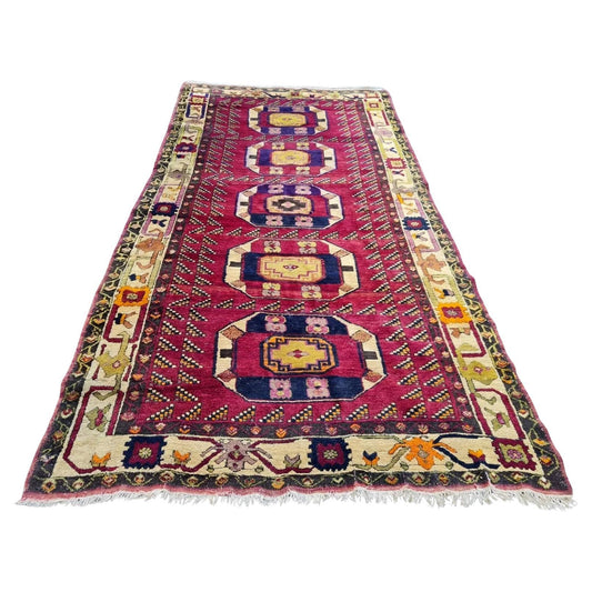 Antique Turkish Anatolian rug with deep red background

