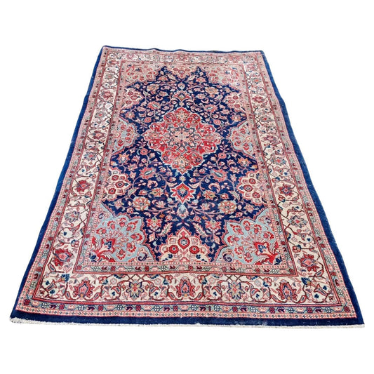 Antique Persian Kashan rug with deep navy blue field

