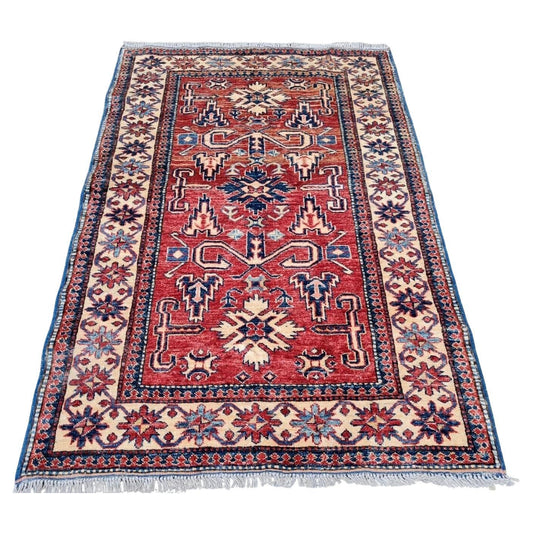 Vintage Perpedil Kazak rug with red and navy design

