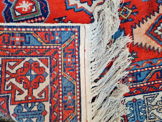 close-up of Caucasian Kazak tribal medallions in blue and ivory
