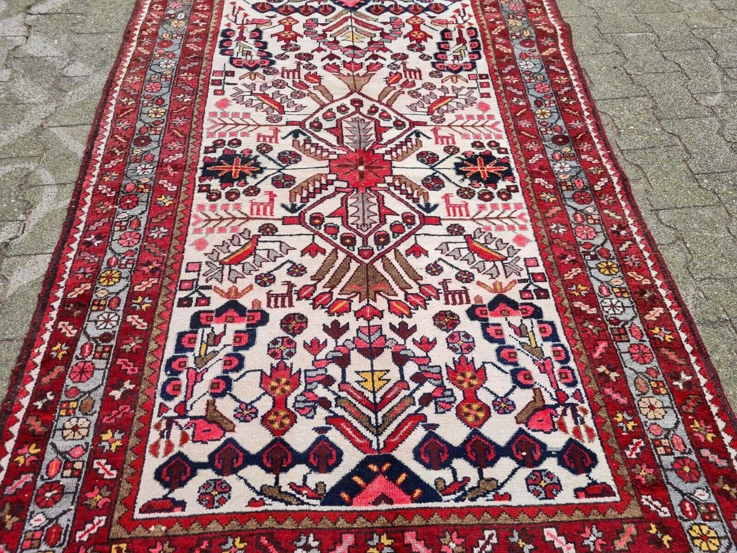 rich navy blue motifs on antique Persian rug
