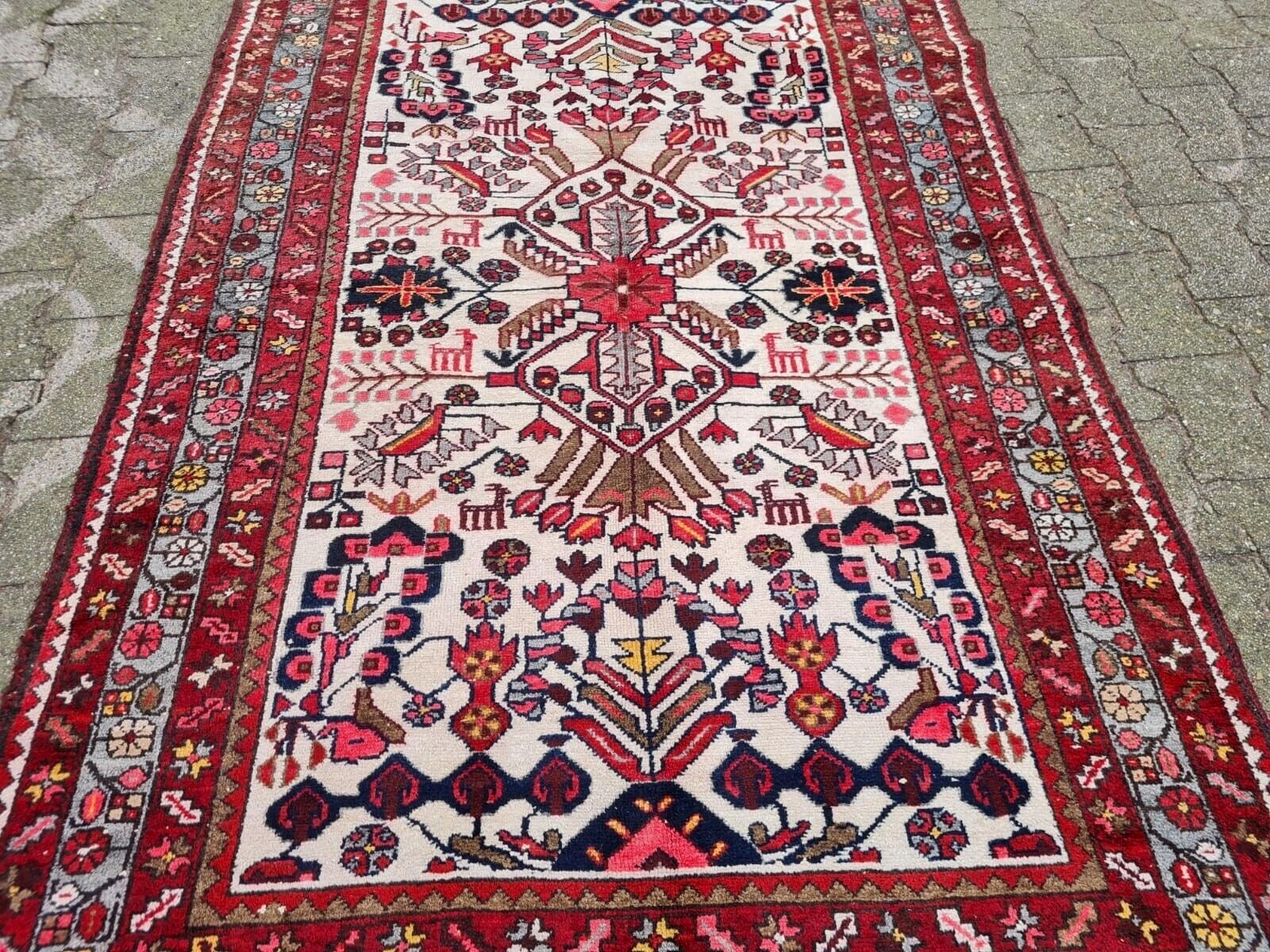 rich navy blue motifs on antique Persian rug
